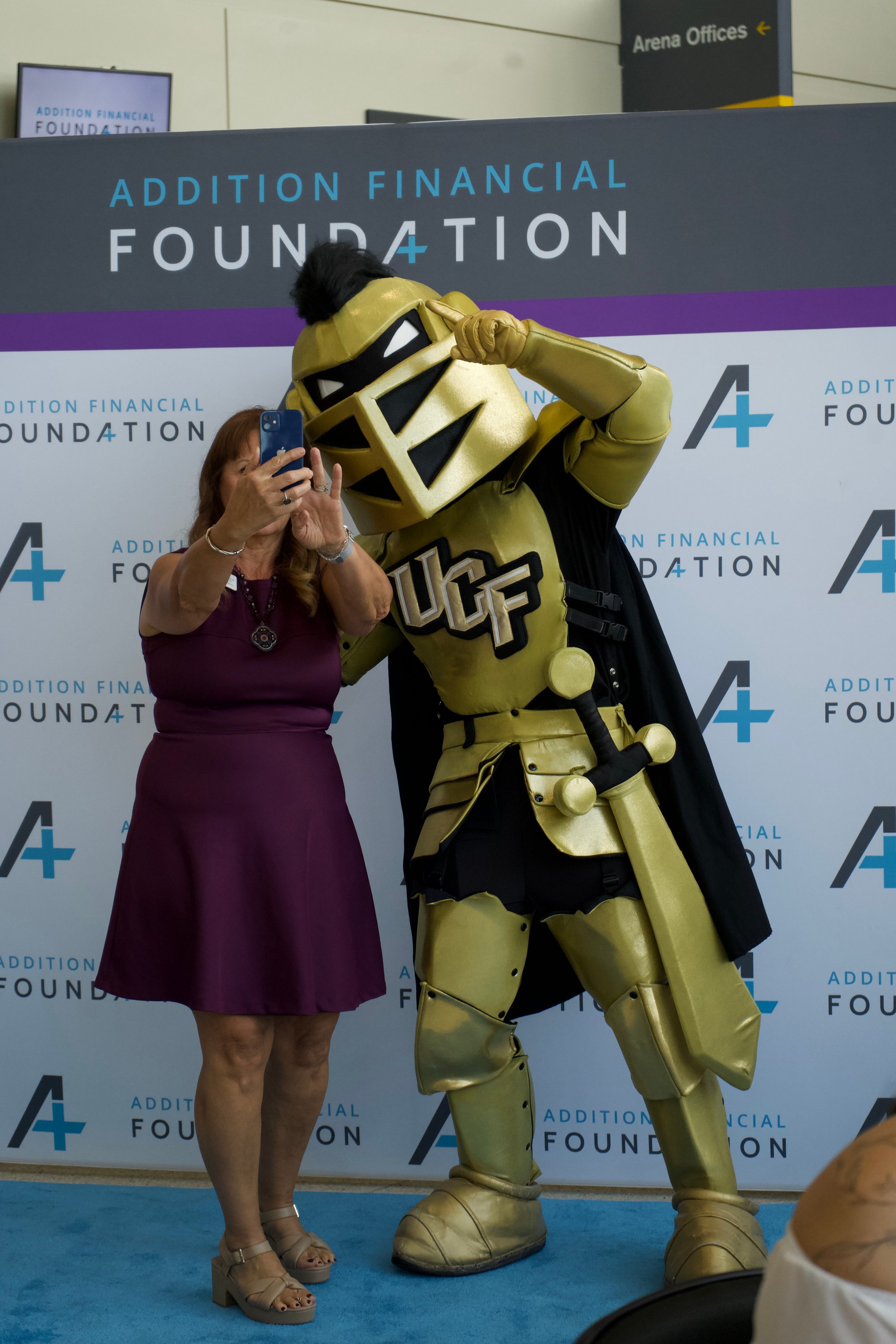 Knightro at Community Giving Event. Taking a selfie. 